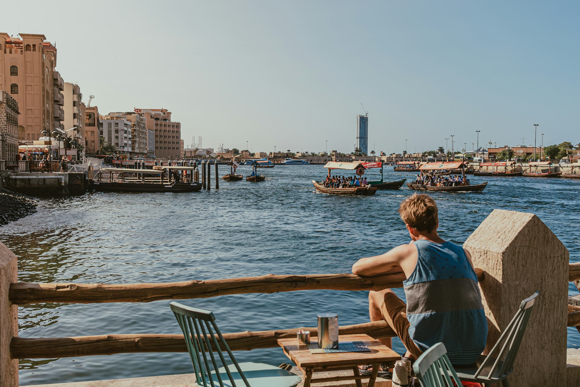 A man sitting at a table looking out over the water